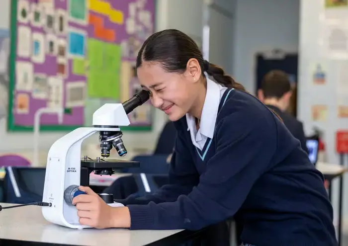 Girl looking into microscope