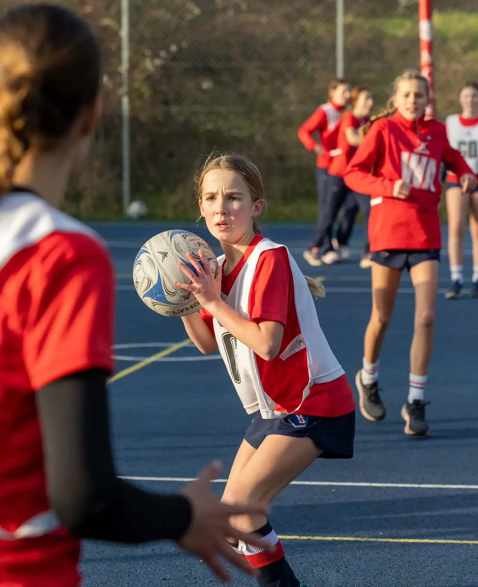 girl passing ball in netball