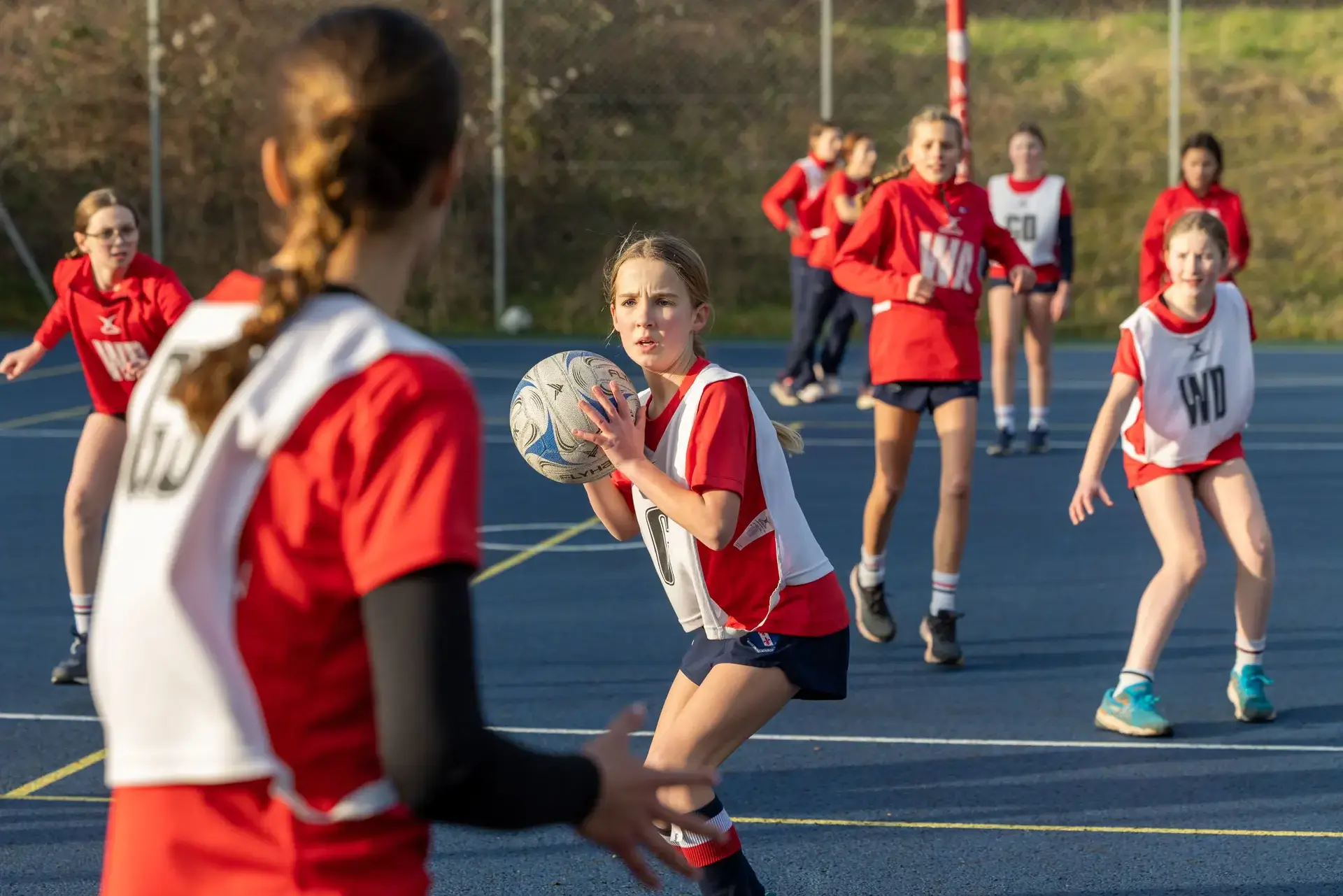 girl preparing to pass netball