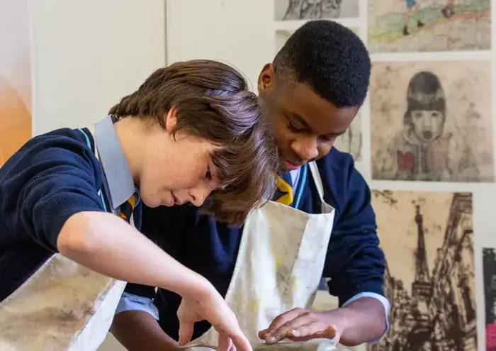 Two boys doing pottery together