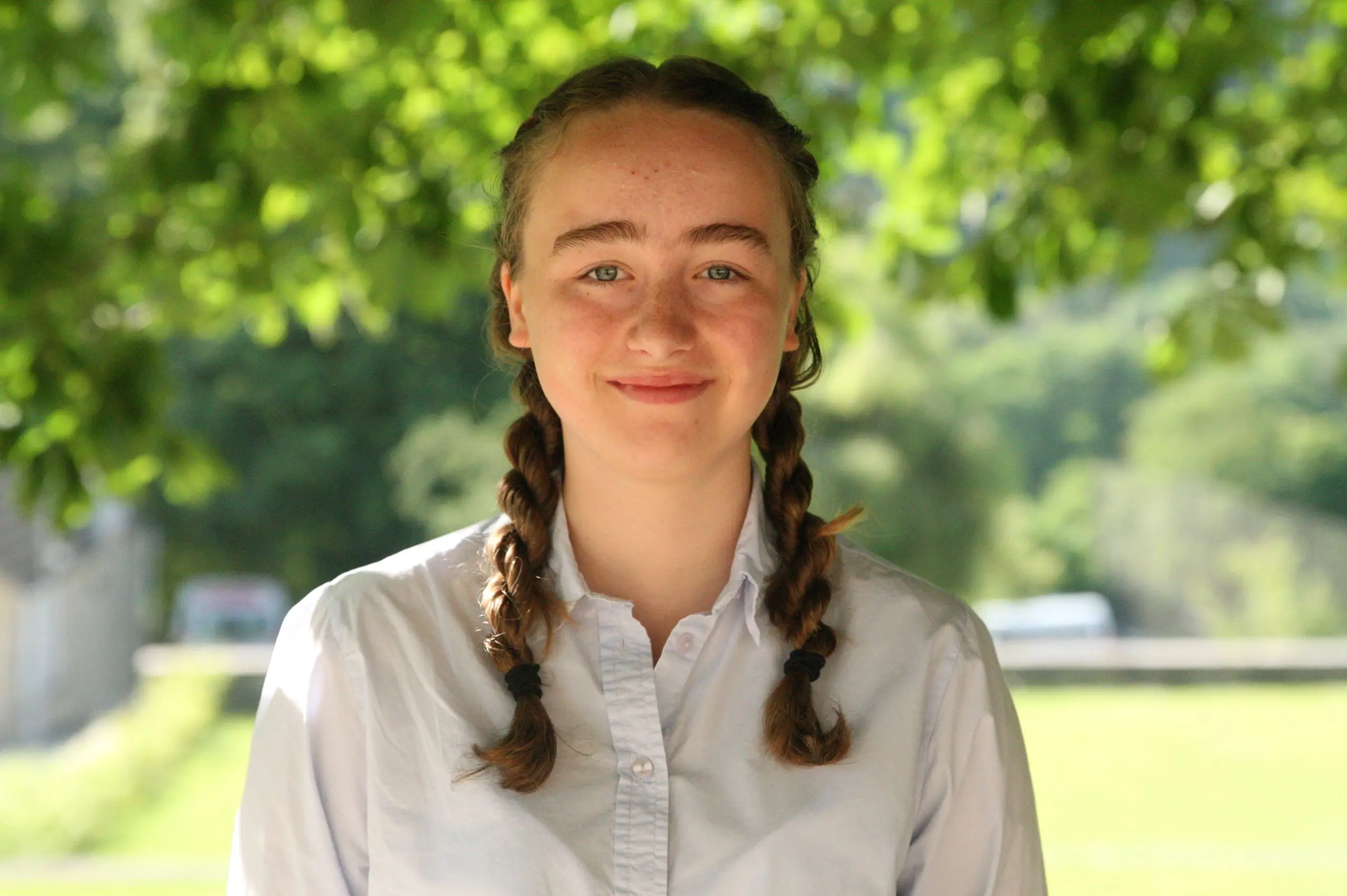 portrait of student outside near trees