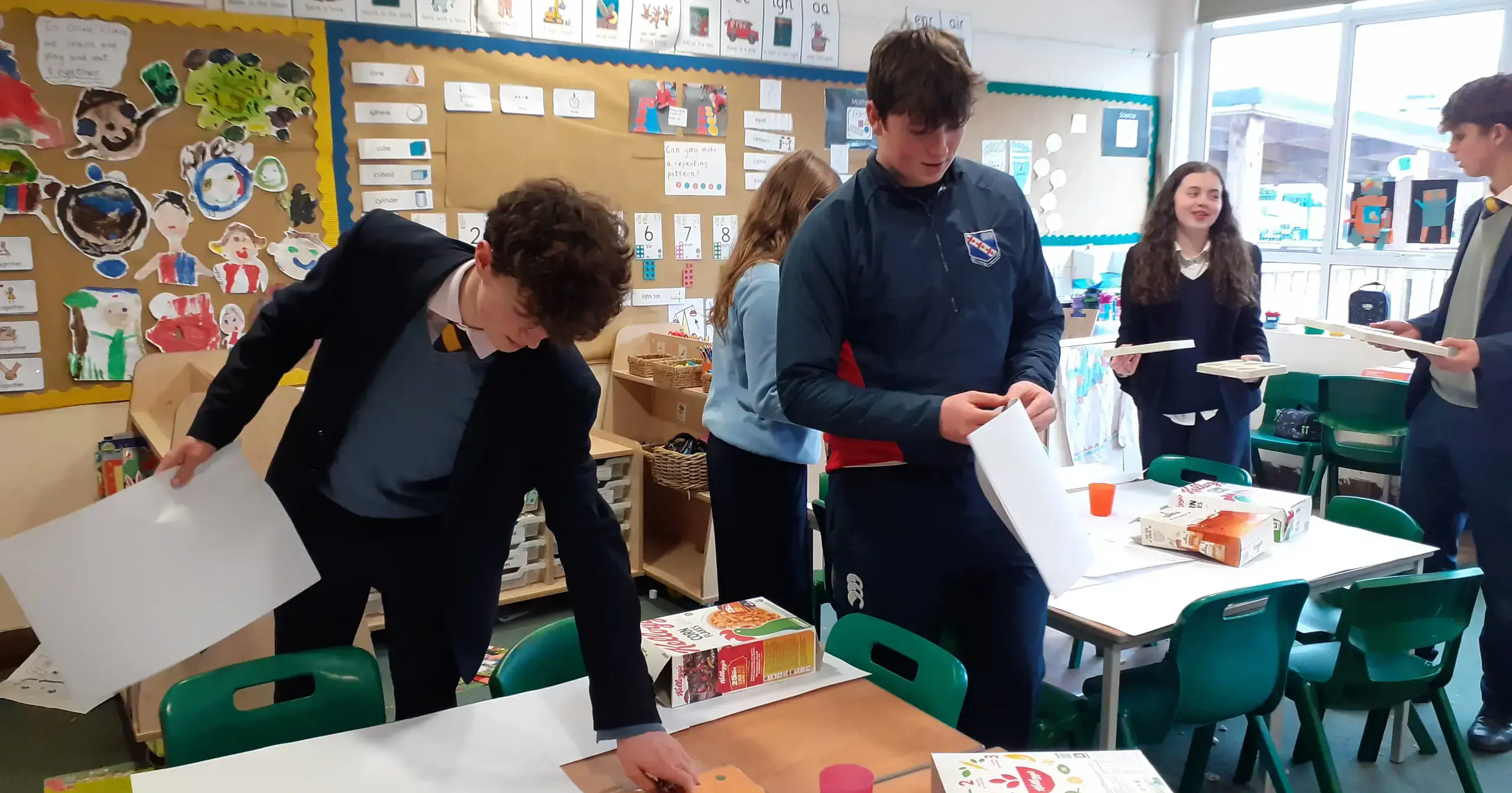 Boys setting out work in class