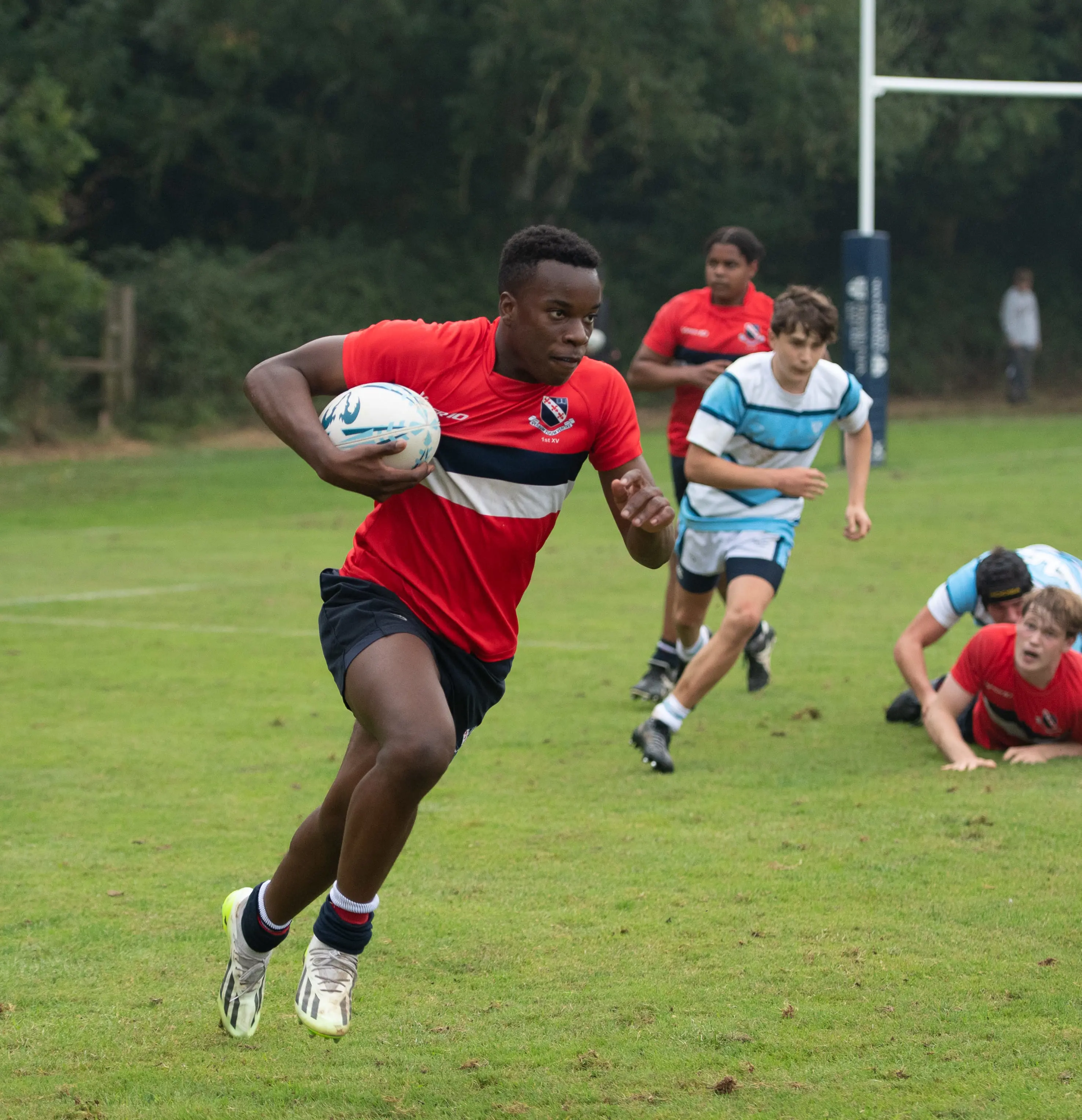 boy running with rugby ball