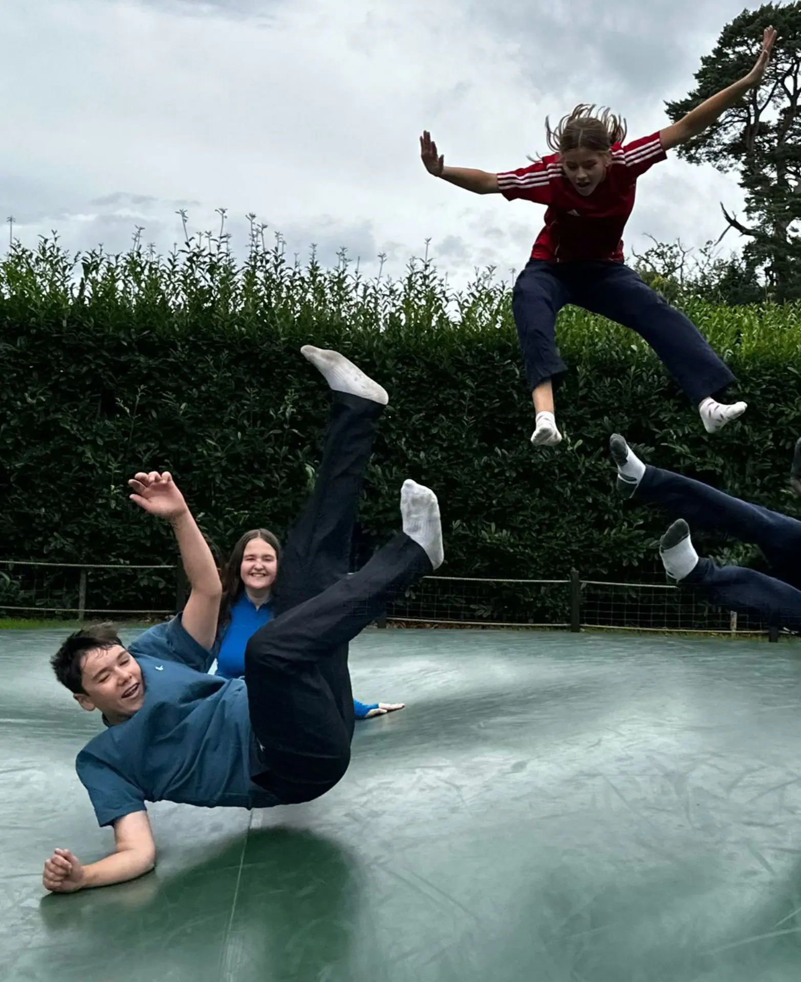 Students jumping on trampoline
