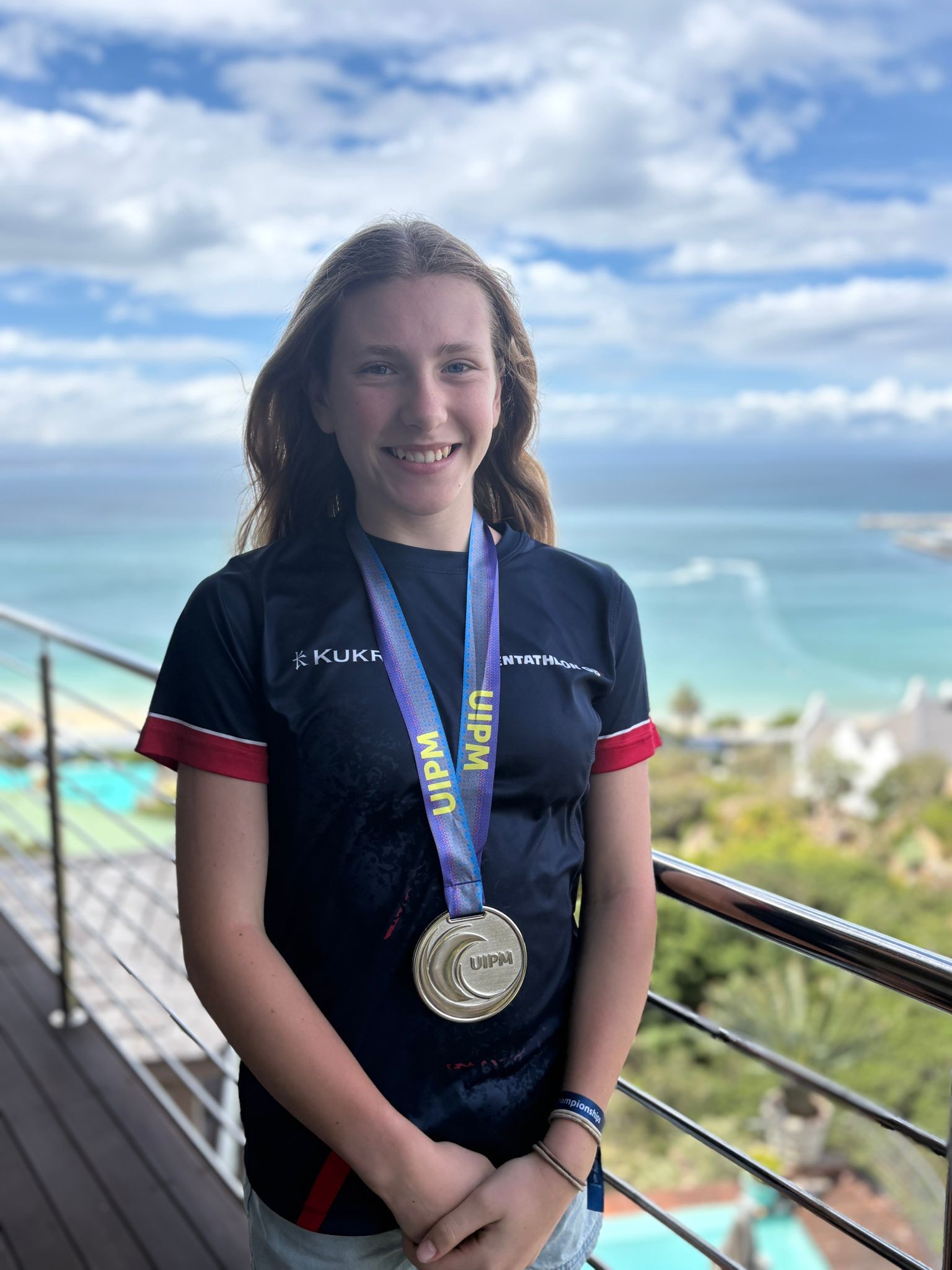 girl stood with gold medal