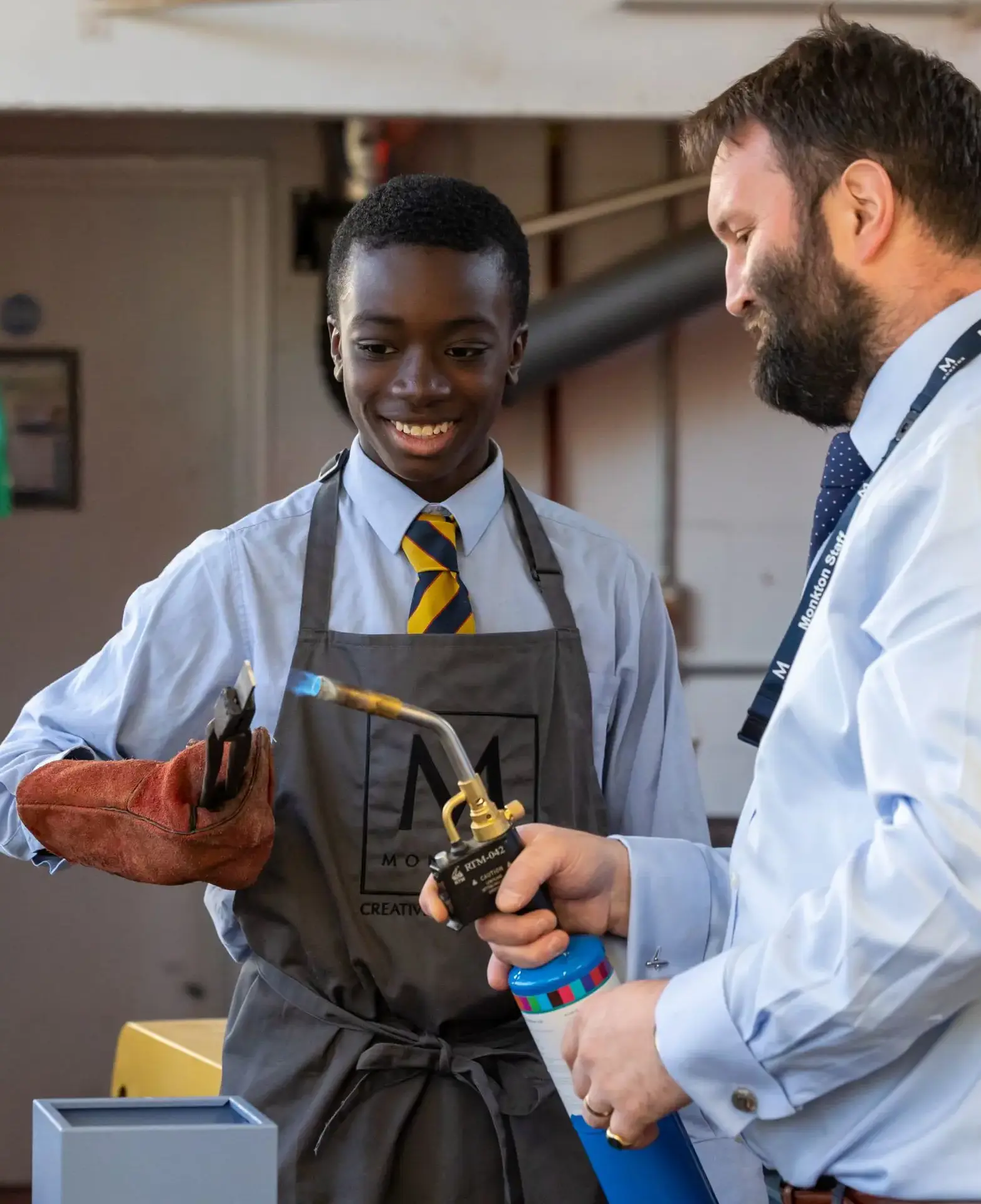 pupil and teacher with blow torch in Design