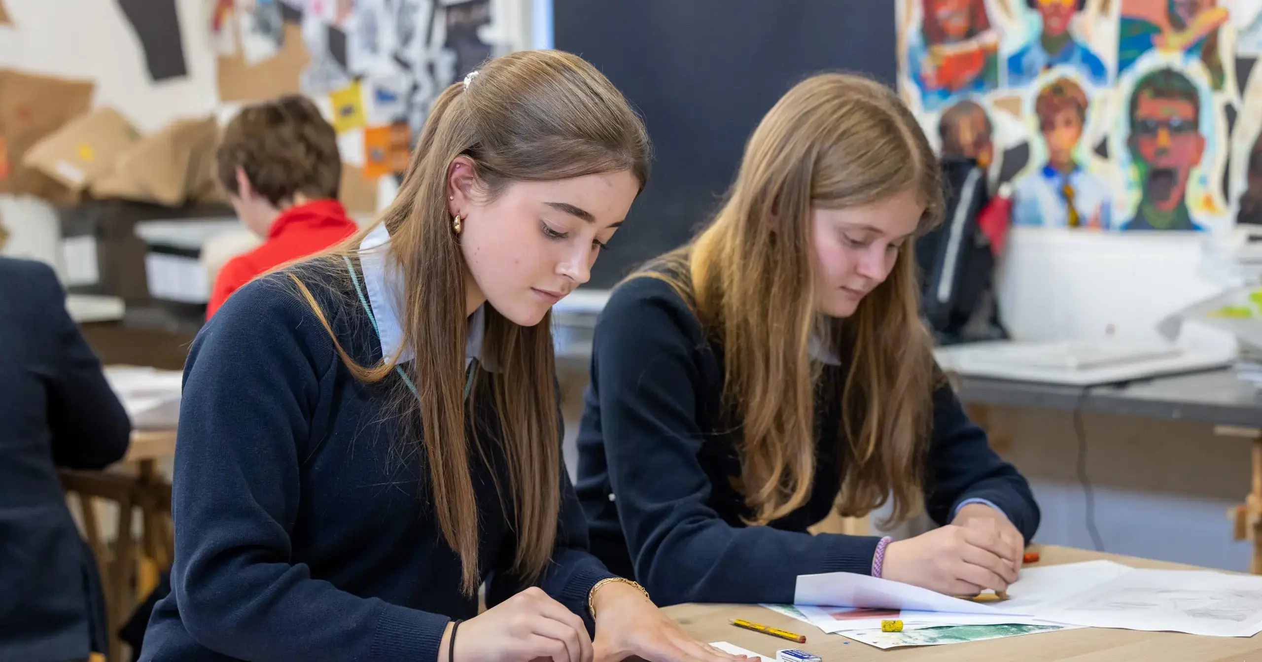 Two girls working at desks