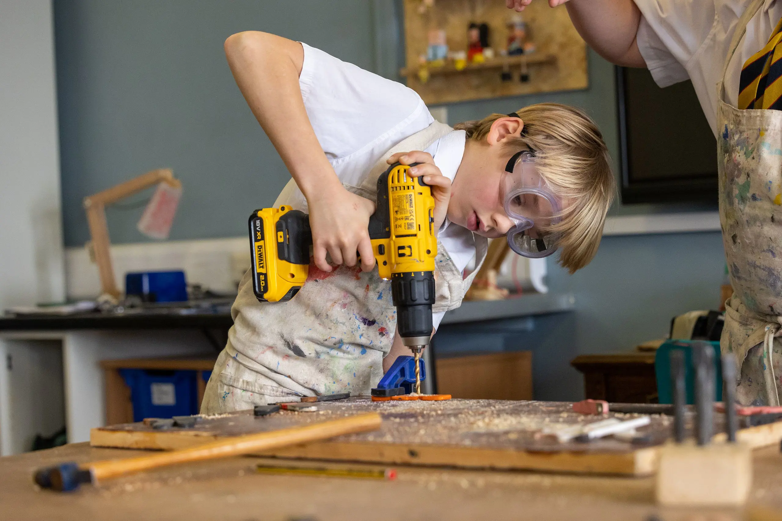 Boy drilling in a design lesson
