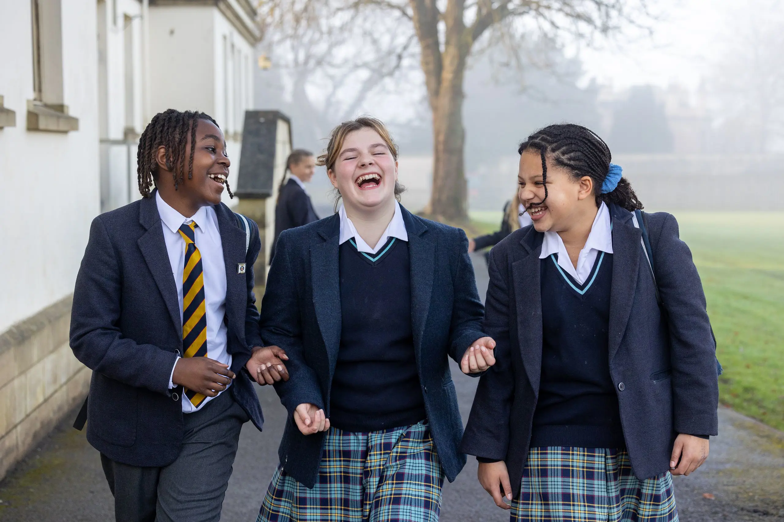 Pupils walking and laughing through campus