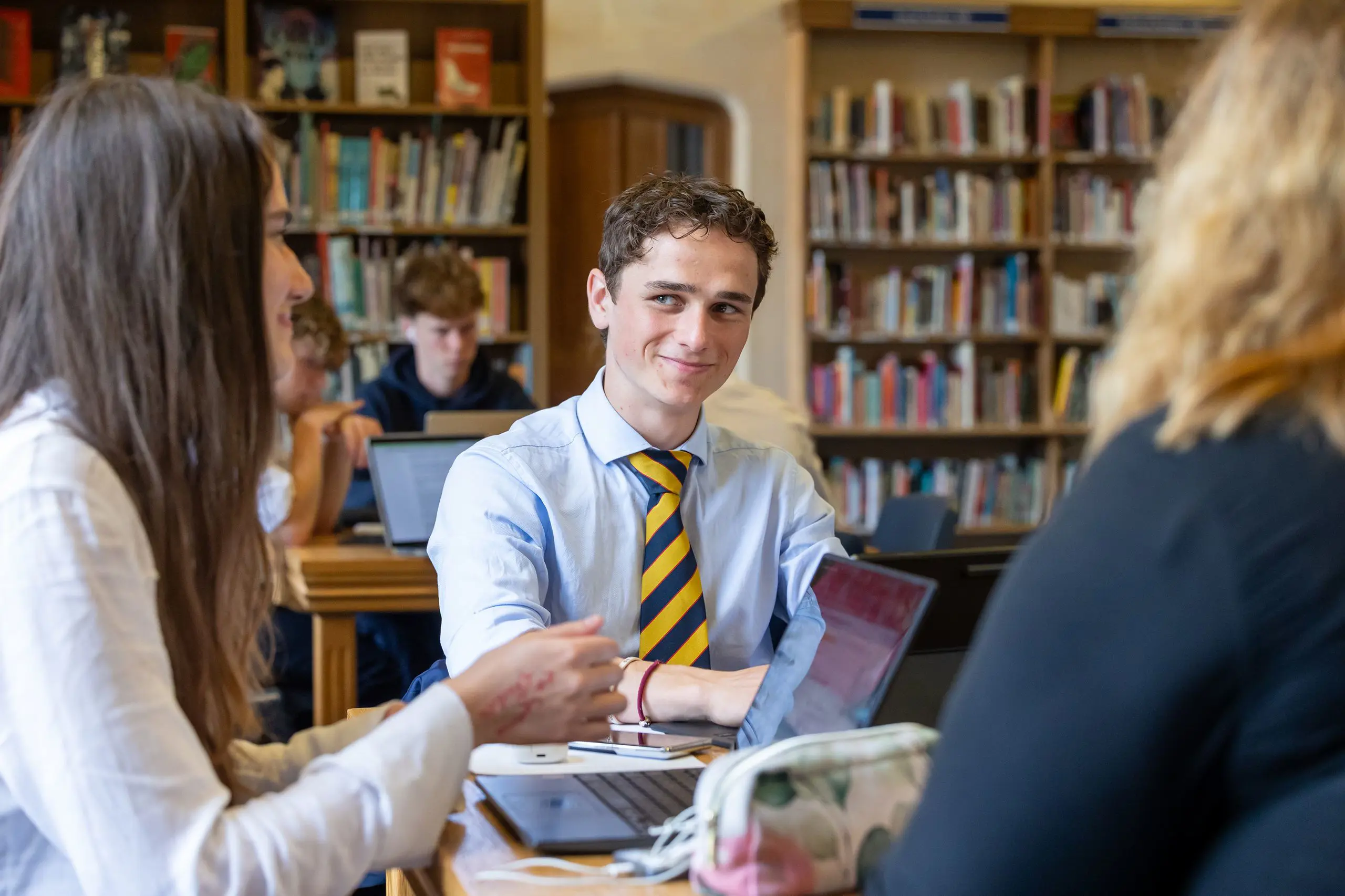 Mixed group of pupils working in library