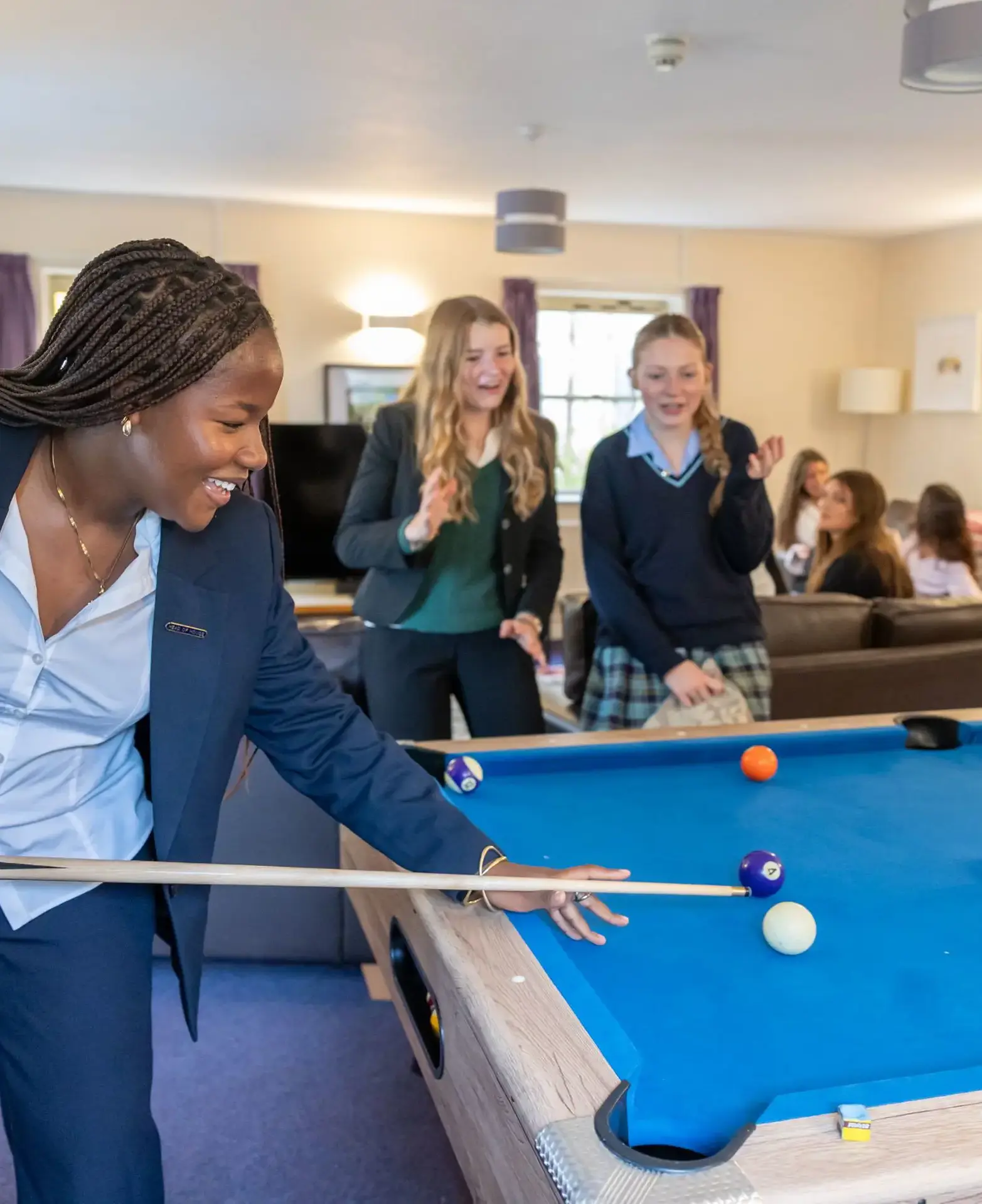  girls playing pool and laughing