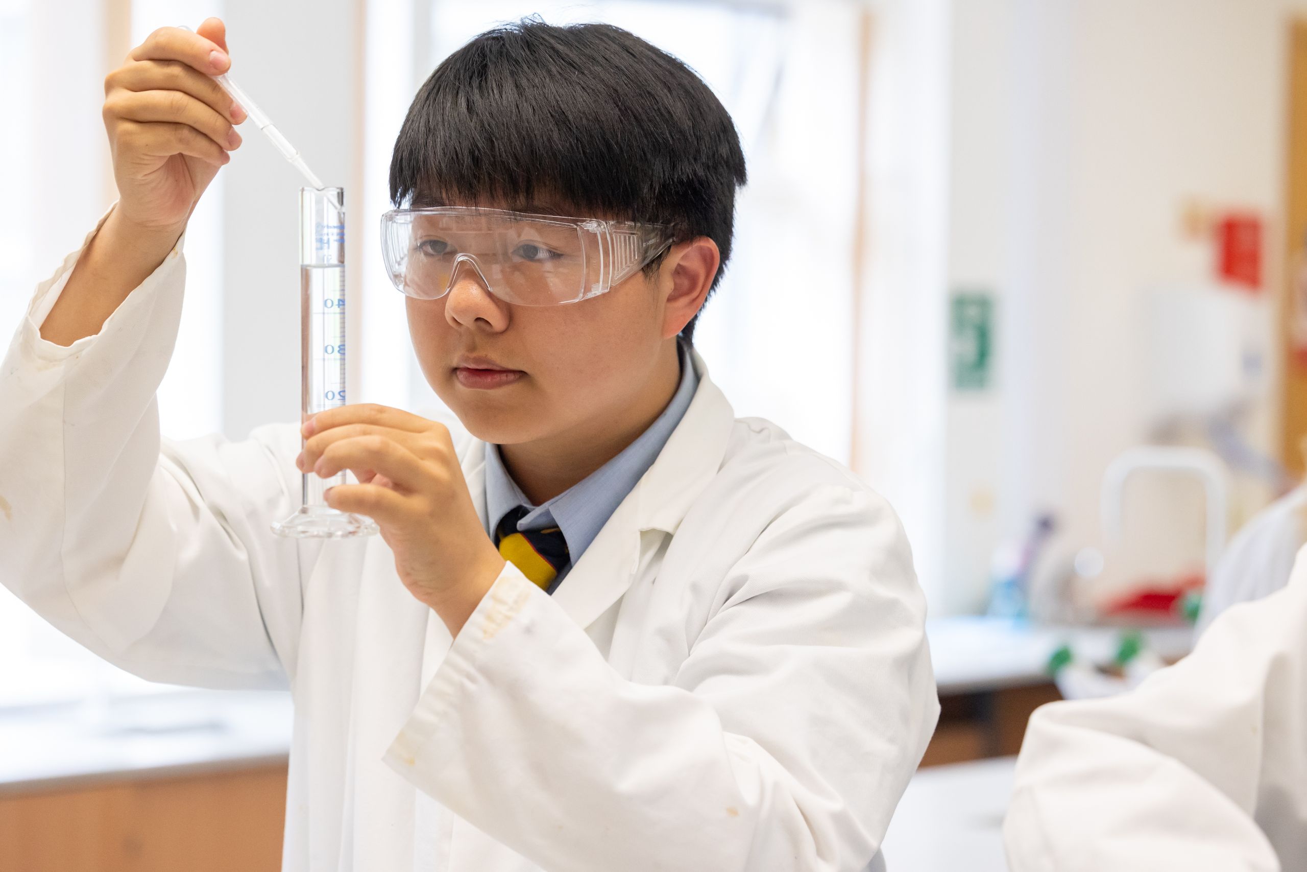 boy looking at science test tube