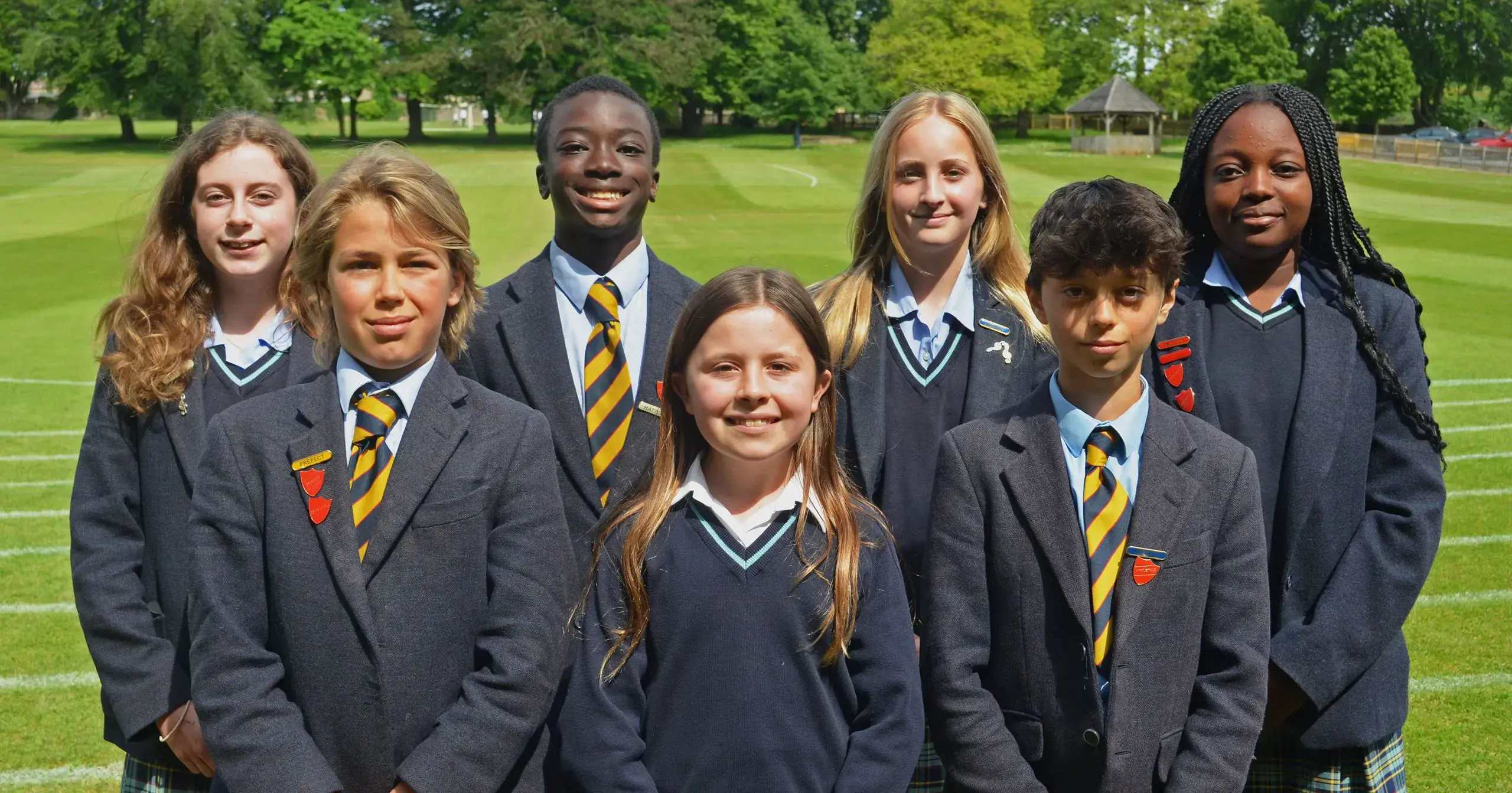Group of prep prefects students standing next to each other for the group photo outdoors