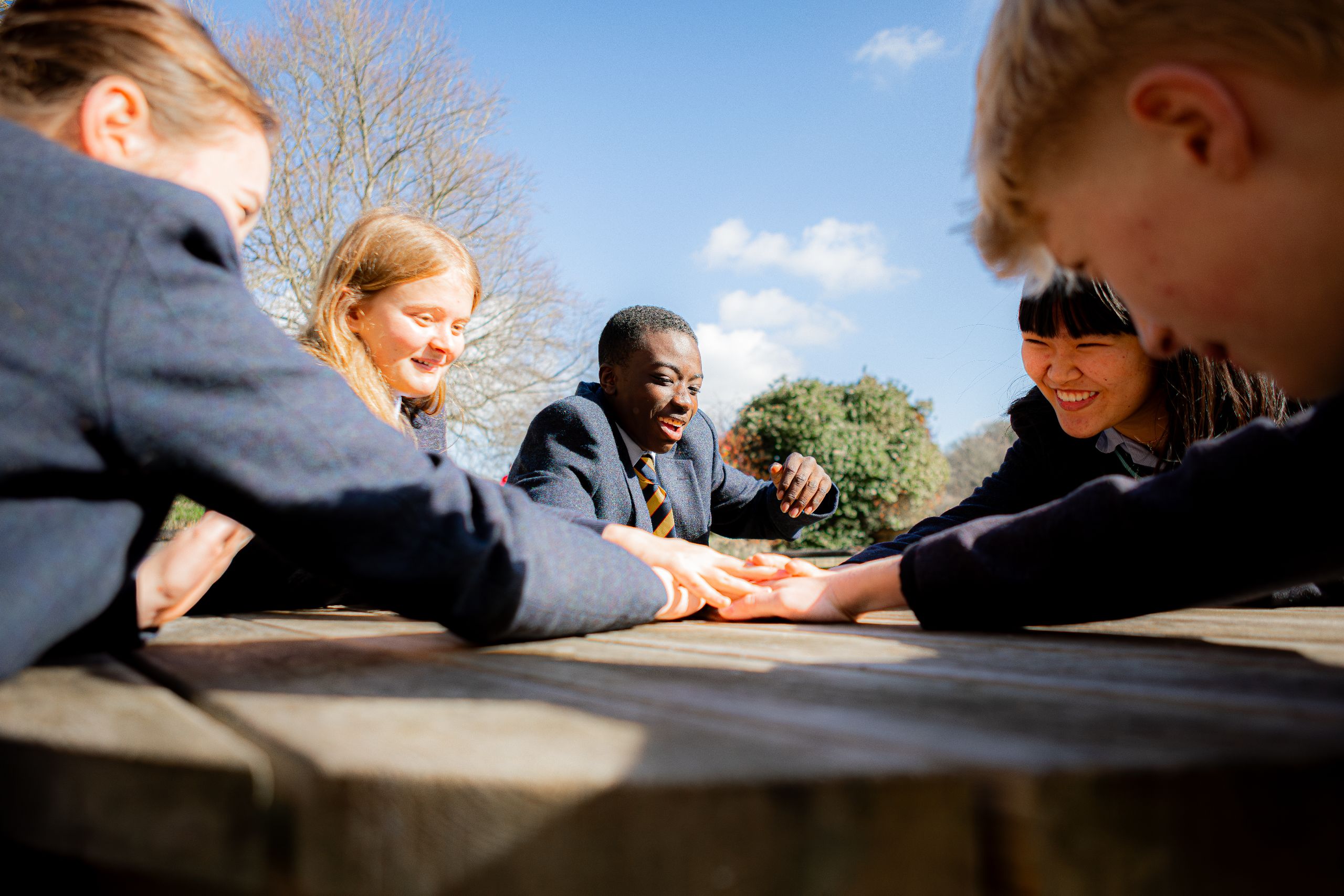 pupils sat on bench smiling