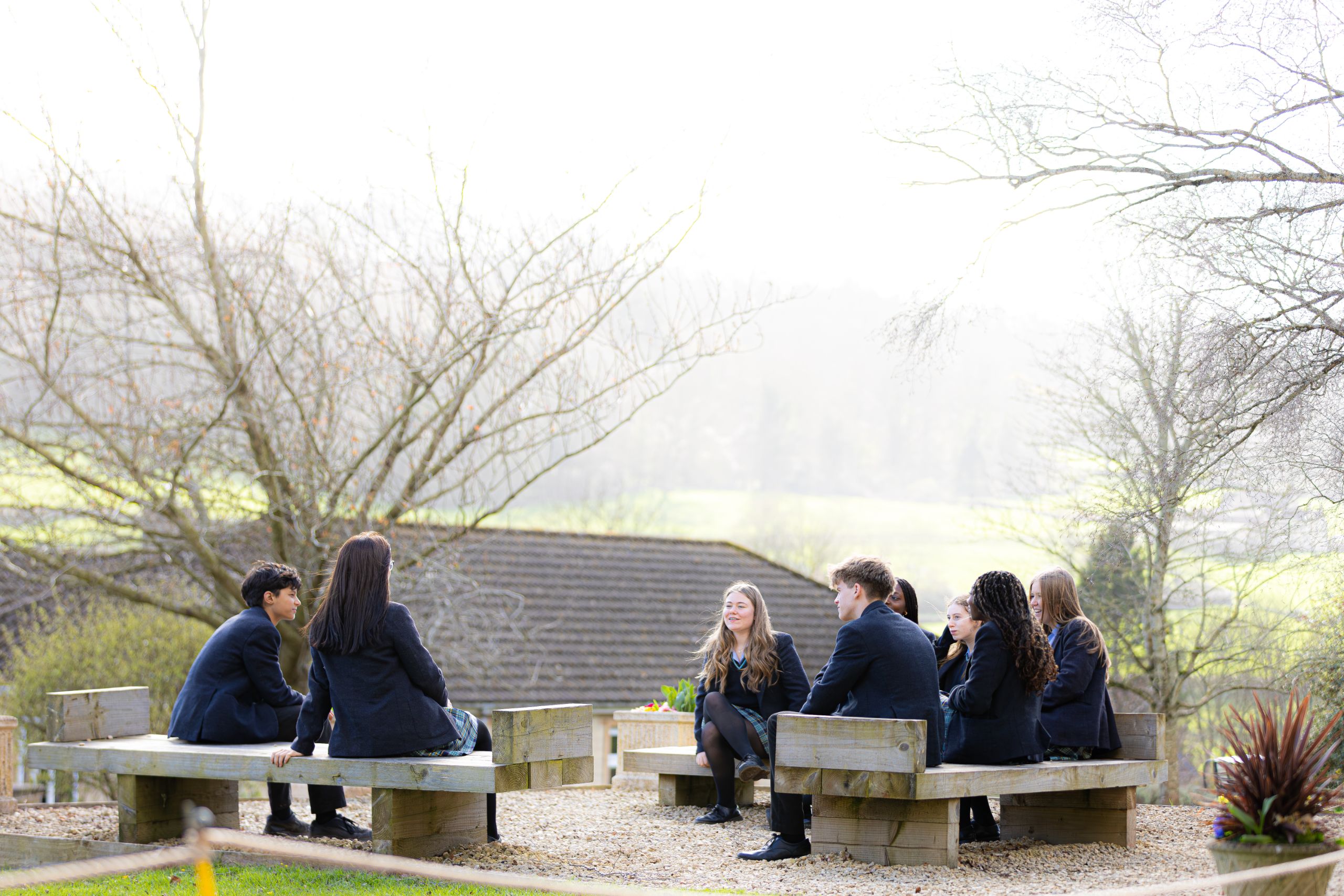 girls and boys sat on benches